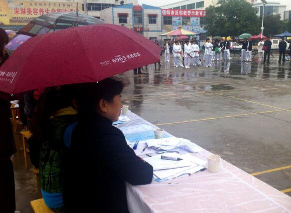 河南洛阳70多岁老人雨中比赛 评委打伞评分